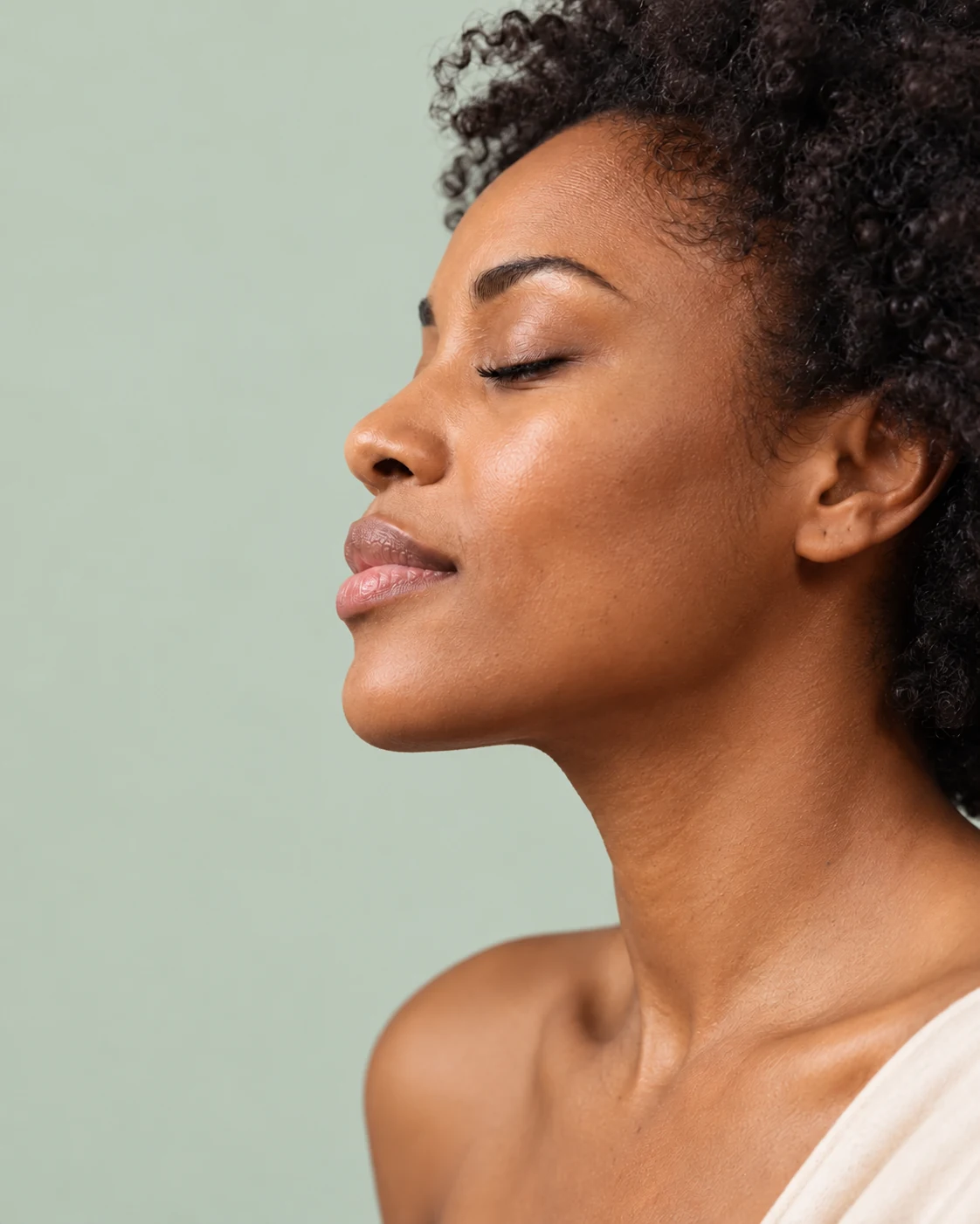 Illustrative portrait of a woman with natural skin texture against a sage-green background